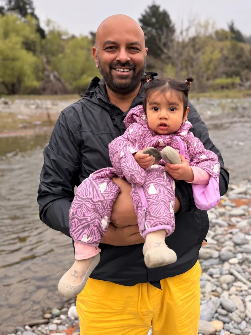 Jeevan by a river with his daughter